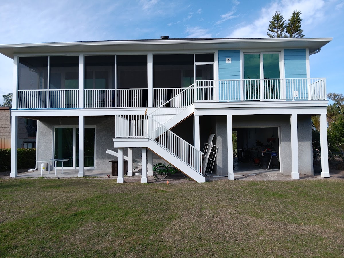 Elevated home with screened porch enclosure